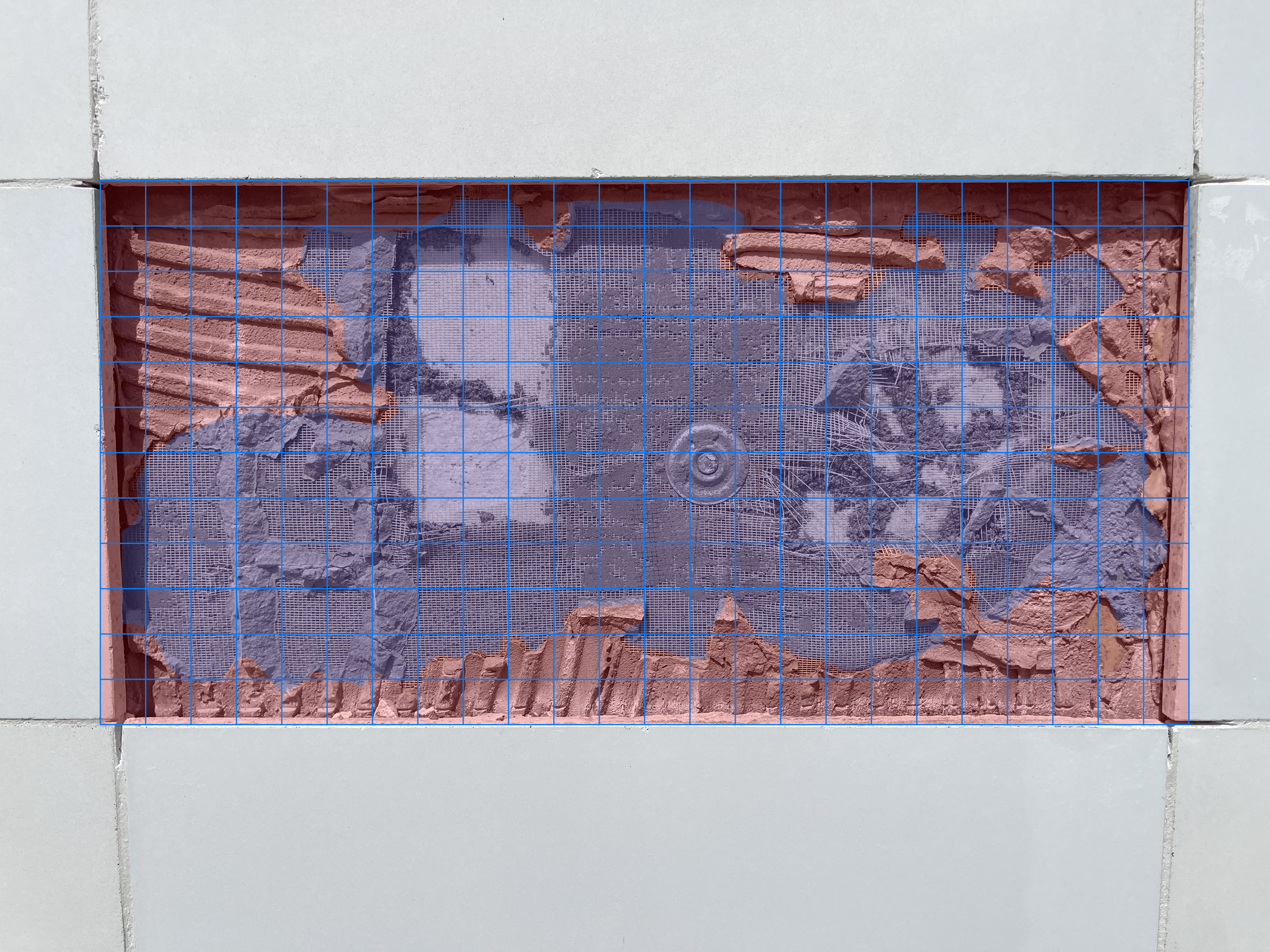 Tile bonding grid showing mortar coverage pattern on exterior wall installation